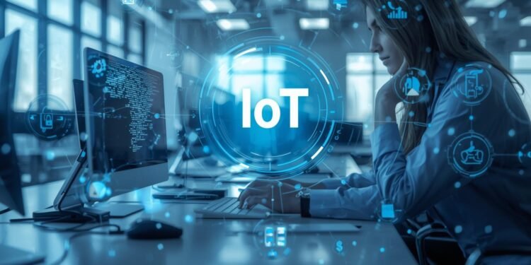 IT engineer monitoring connected IoT devices and real-time data dashboards in a modern smart workplace.
