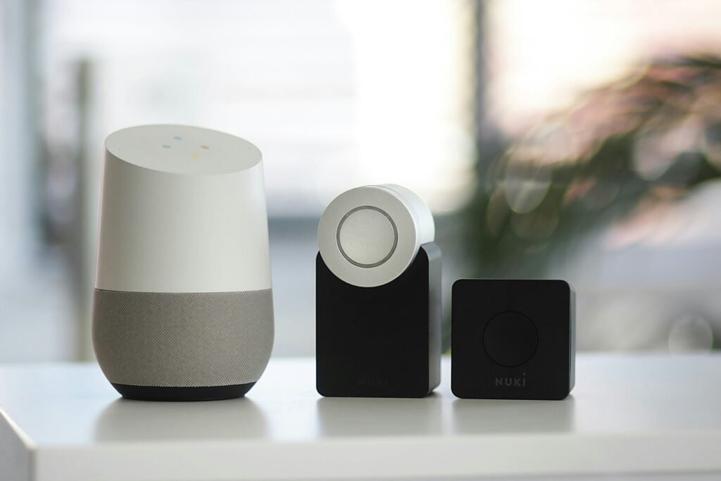 Smart home devices including a smart speaker and connected lock modules placed on a table in a home setting.